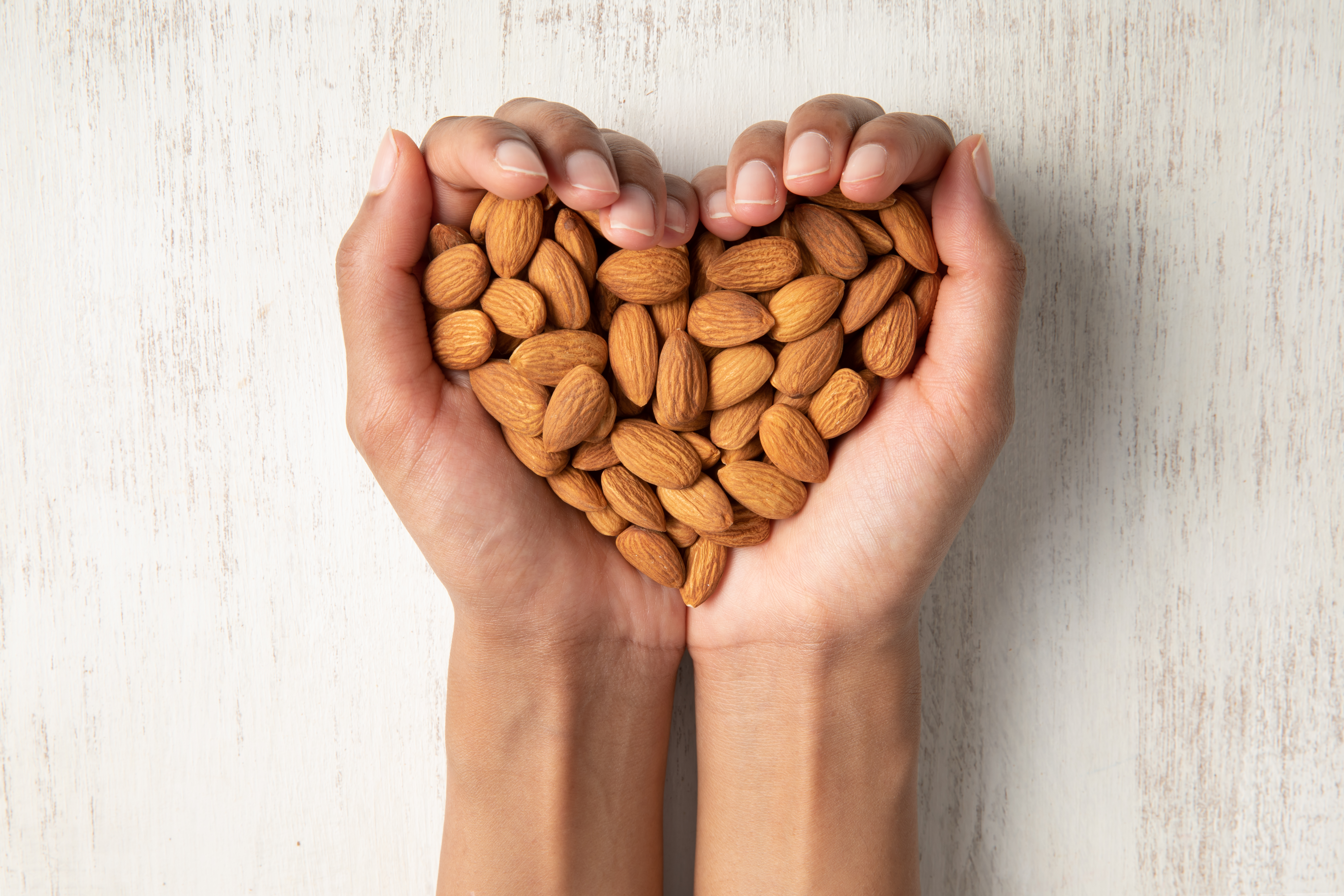 Handful of almonds in heart shape